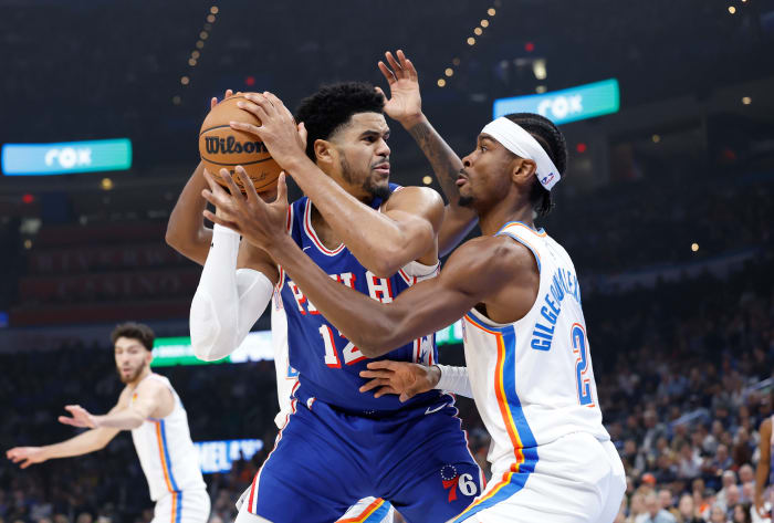 Nov 25, 2023; Oklahoma City, Oklahoma, USA; Oklahoma City Thunder guard Shai Gilgeous-Alexander (2) defends a drive by Philadelphia 76ers forward Tobias Harris (12) during the first quarter at Paycom Center.